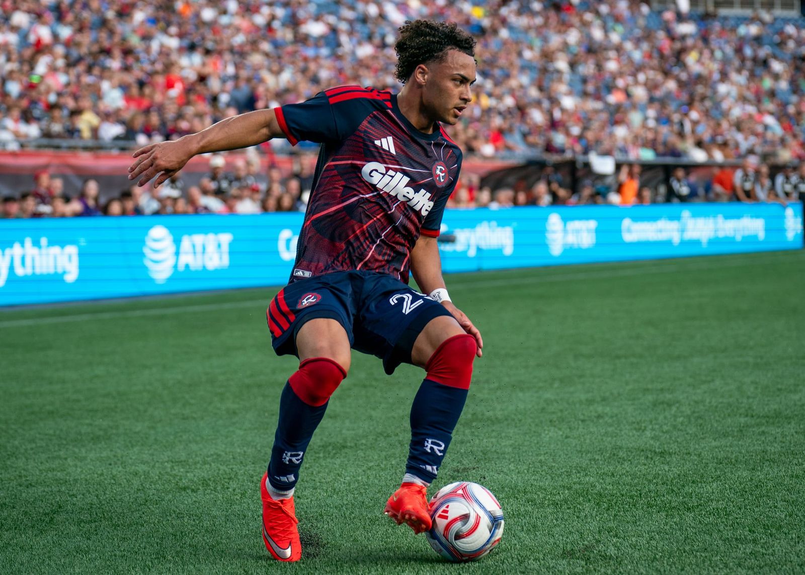 New England Revolution winger Peyton Miller dribbles with the ball in a match at Gillette Stadiu