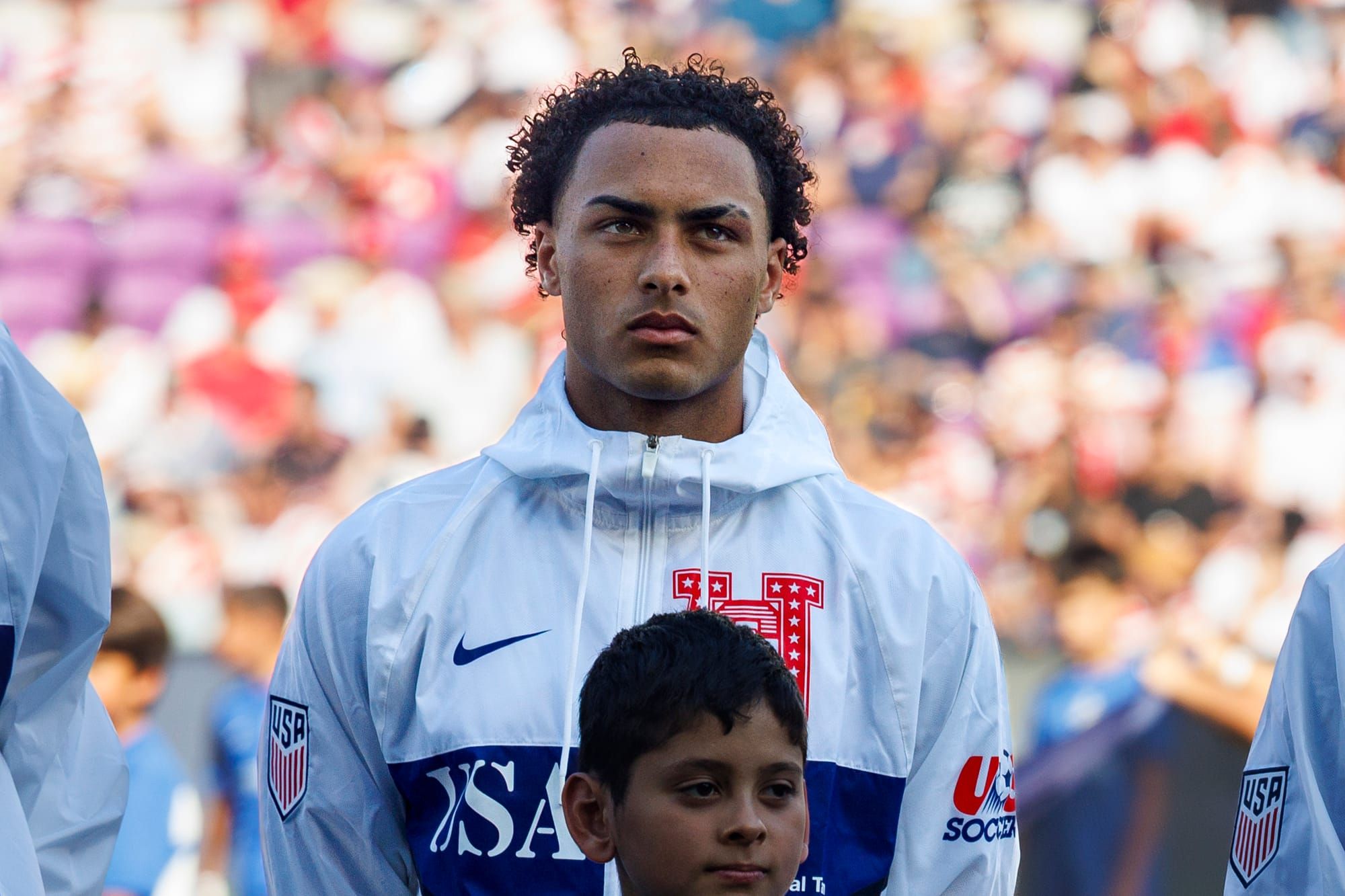 Peyton Miller stands with teammates during a United States Men's National Team match