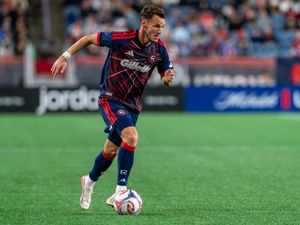 Revolution forward Daniel azdag dribbles towards goal 