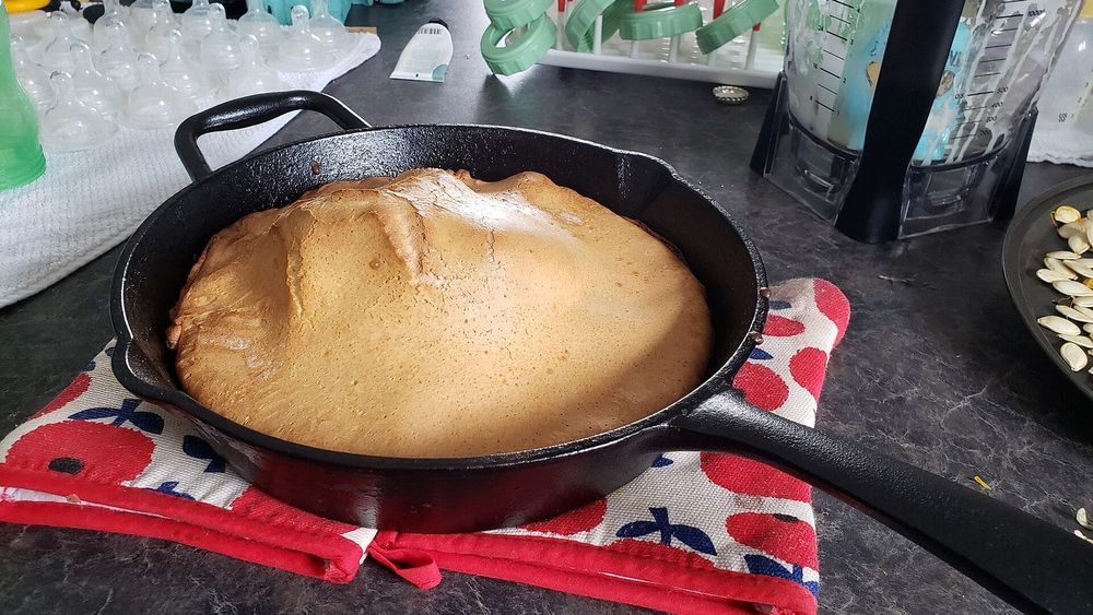 Puffed Dutch baby pancake in a cast iron skillet