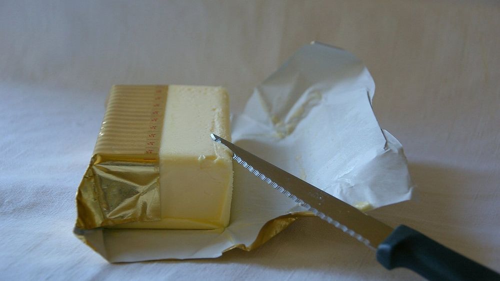 A block of butter on its foil wrapper with a knife — photo for the seed-oil-free guide: Tallow vs Butter