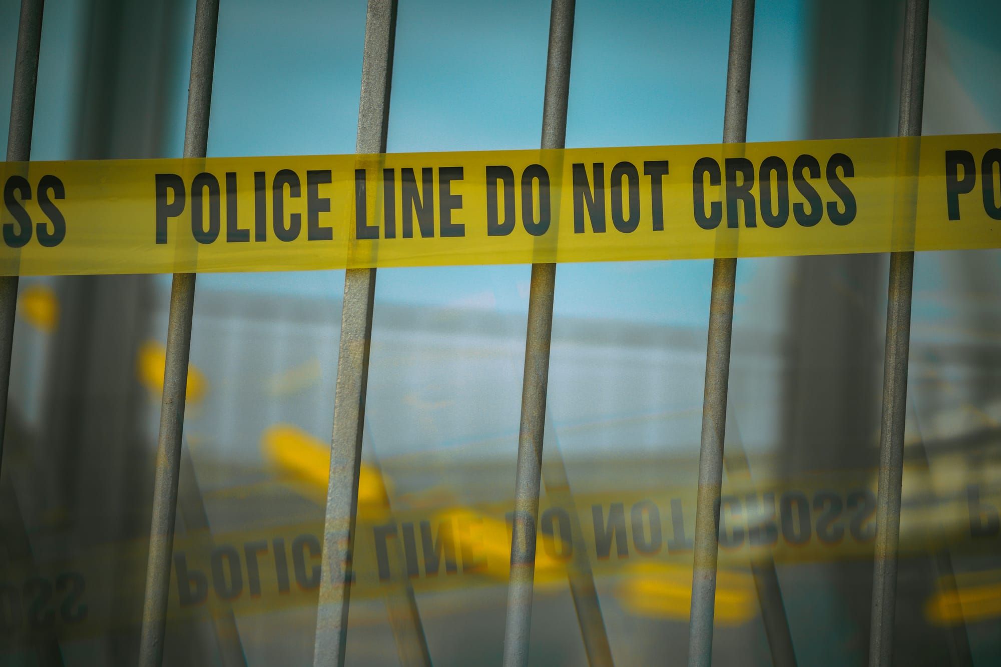 Bars wrapped with 'Police Line Do Not Cross' tape