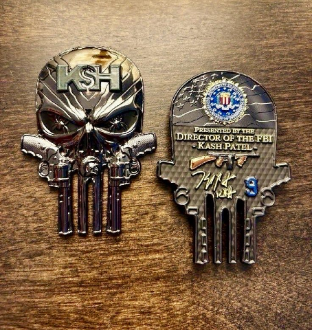 Kash Patel's challenge coin. It is a golden "Punisher" logo with pistols forming part of the design