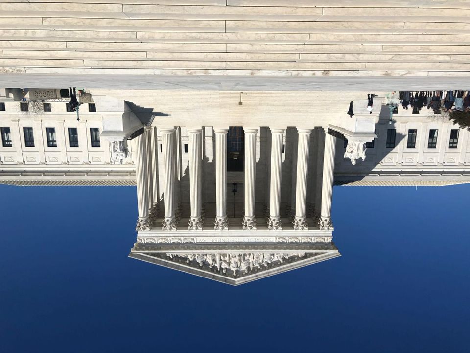 Picture of the Supreme Court building in Washington DC, but flipped upside down. Photo credit Marielam1 