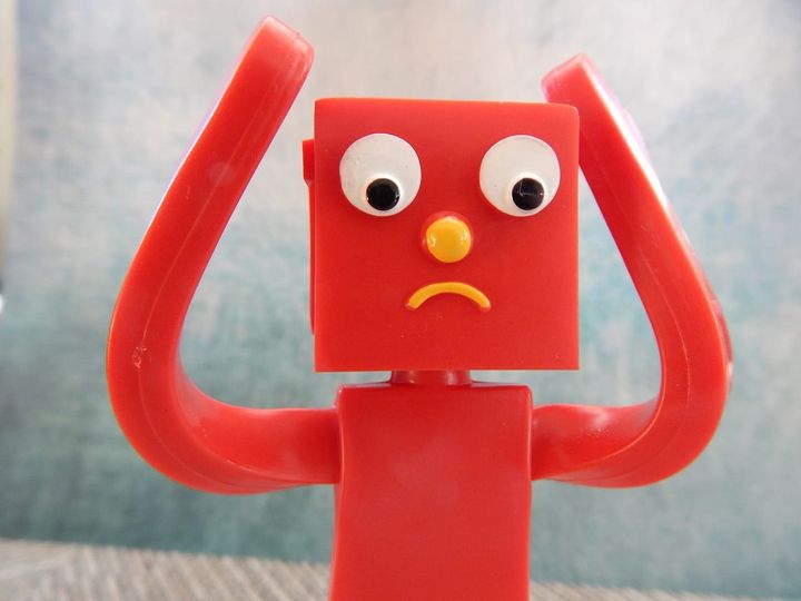 A red, square-headed figure looking confused, upset, or both