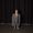 Artwork for Odd Beholder's new single Like A Chore. A girl in front of a black curtain wearing an adult-sized jacket.