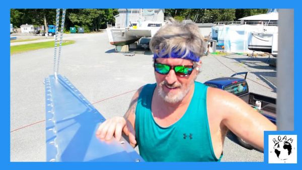 Installing a custom-designed bowsprit on a cruising catamaran crossbeam during a sailboat refit.