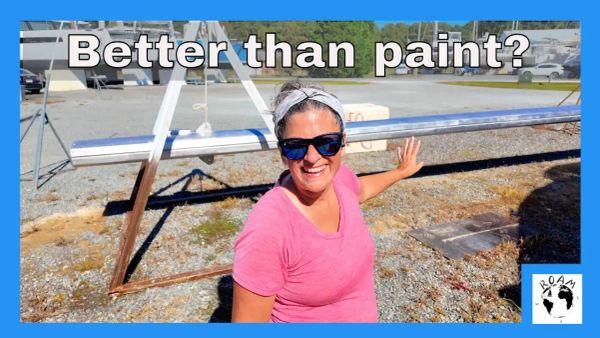Restored aluminum mast and spars laid out in a boatyard after refinishing during a major refit.