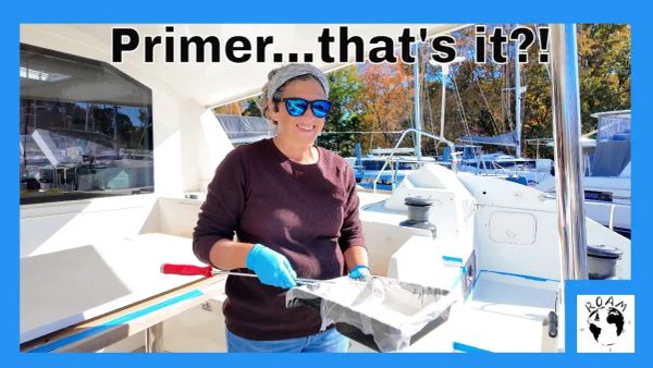 Geri and Shawn priming the aft deck of their cruising catamaran during a winter refit paused by cold weather.
