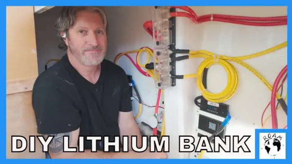 Shawn sits in the battery box surrounded by bus bars and wiring