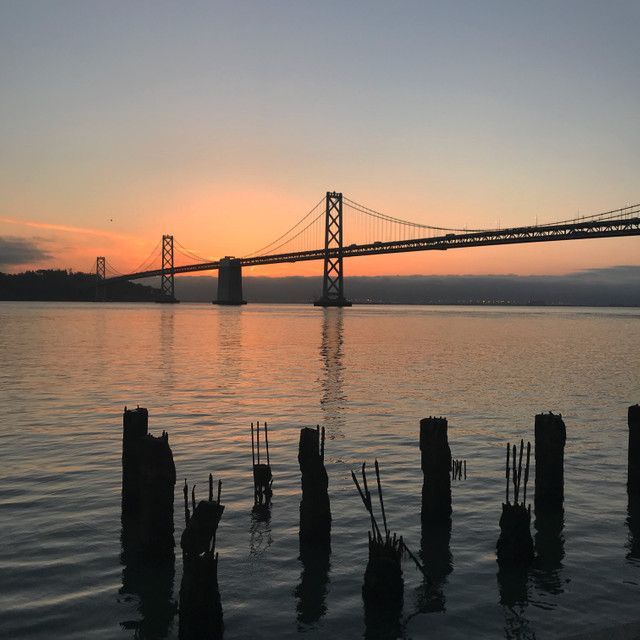The Bay Bridge at sunset as seen from an East Bay dock.