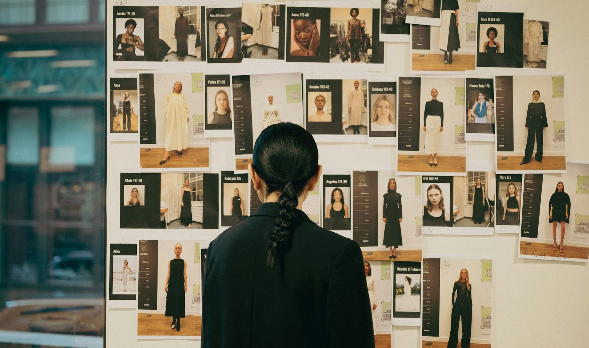 Person looks at mood board with fashion designs