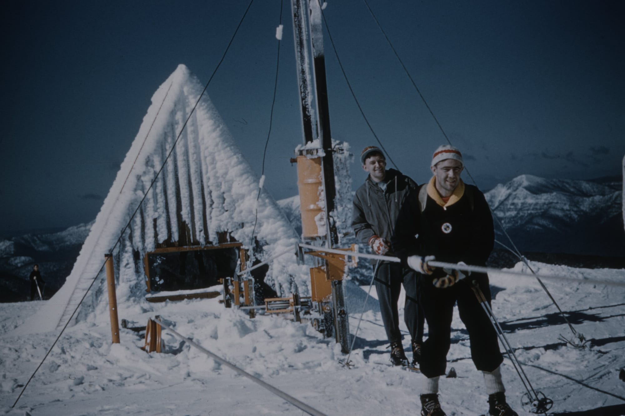 SUMMIT ACCESS TOW 1959: Small A frame on Little Baldy housing the drive unit for the Summit Access rope tow with Robin Williams gripping the rope, and John Johnson waiting behind. PHOTO: Supplied