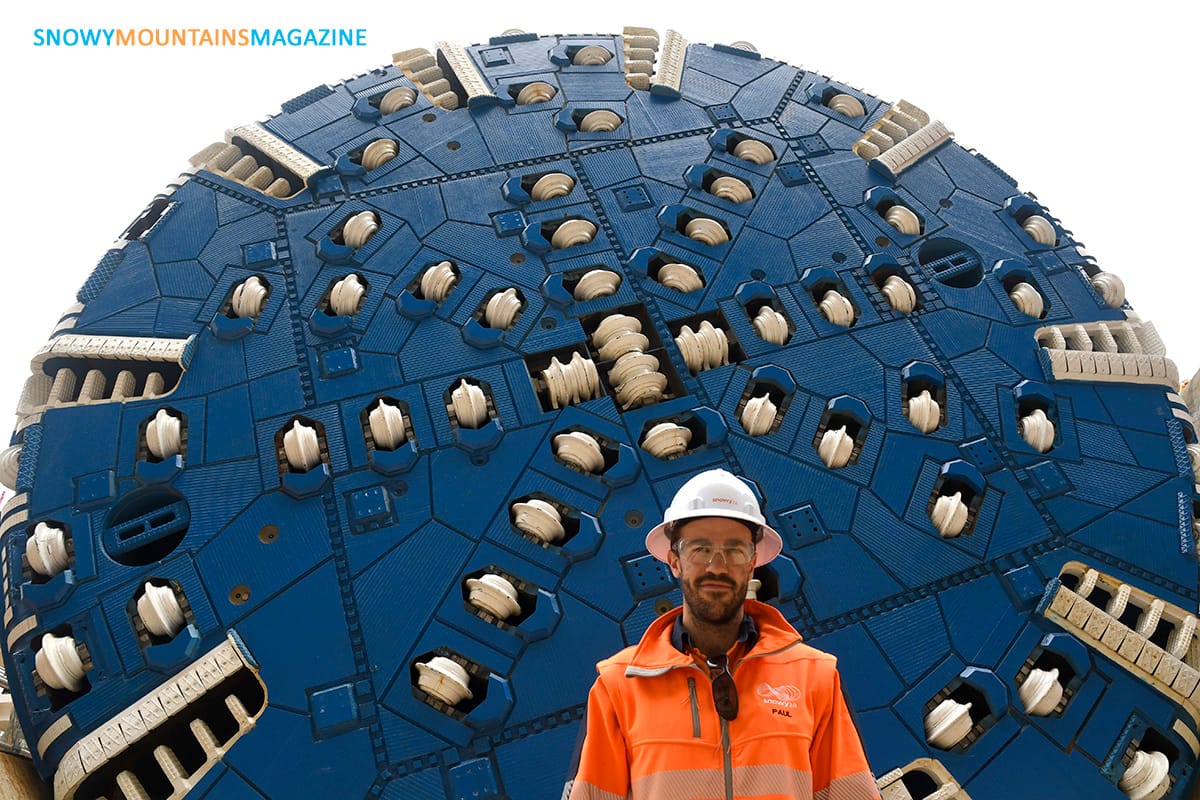 Snowy2.0 Project Manager Paul Smith in front of the 11 metre cutting wheel.