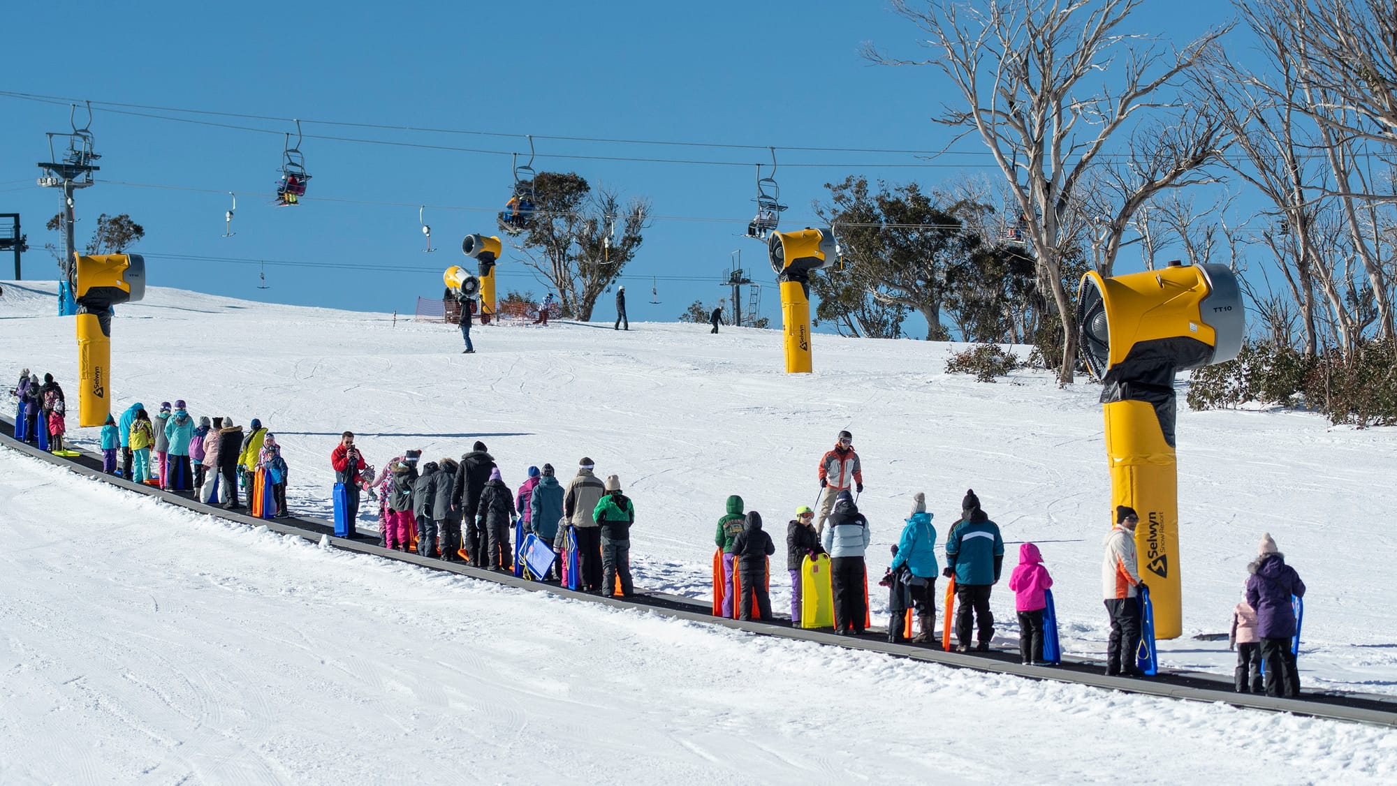 Riding the toboggan snow carpet to the top.