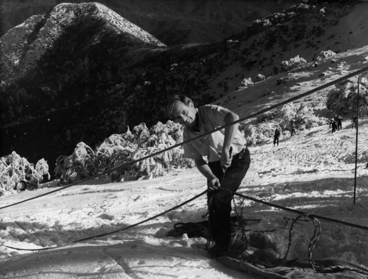 BLUE LIFT FOUNDER: John Hilton-Wood undertaking maintenance on the Bull Run rope tow, probably 1953-1955. PHOTO: Eric Burt, McColl Collection, NAMA