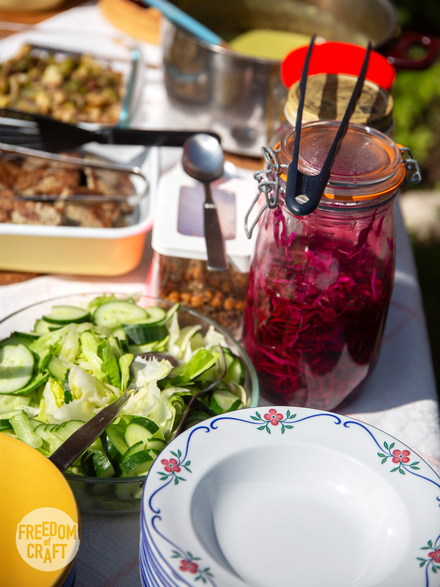 Food served on a table. Salad, pickled red cabbage and omelette.