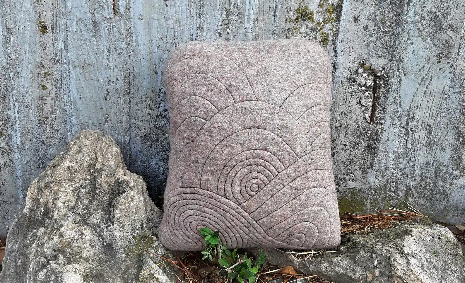 Felted cushion with flowing relief stitchning.
