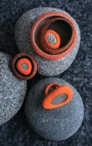 Brooch and rings with incased pebbles.