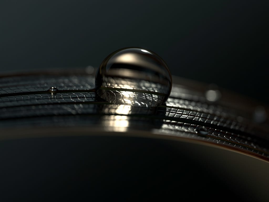 Close-up of a water droplet on a healthy hair strand