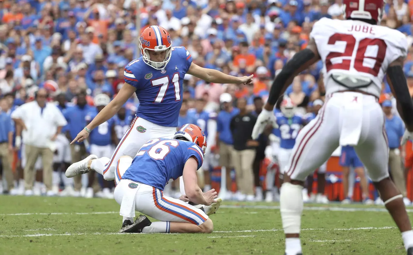 A Florida kicker attempts a kick against Alabama at Ben Hill Griffin Stadium