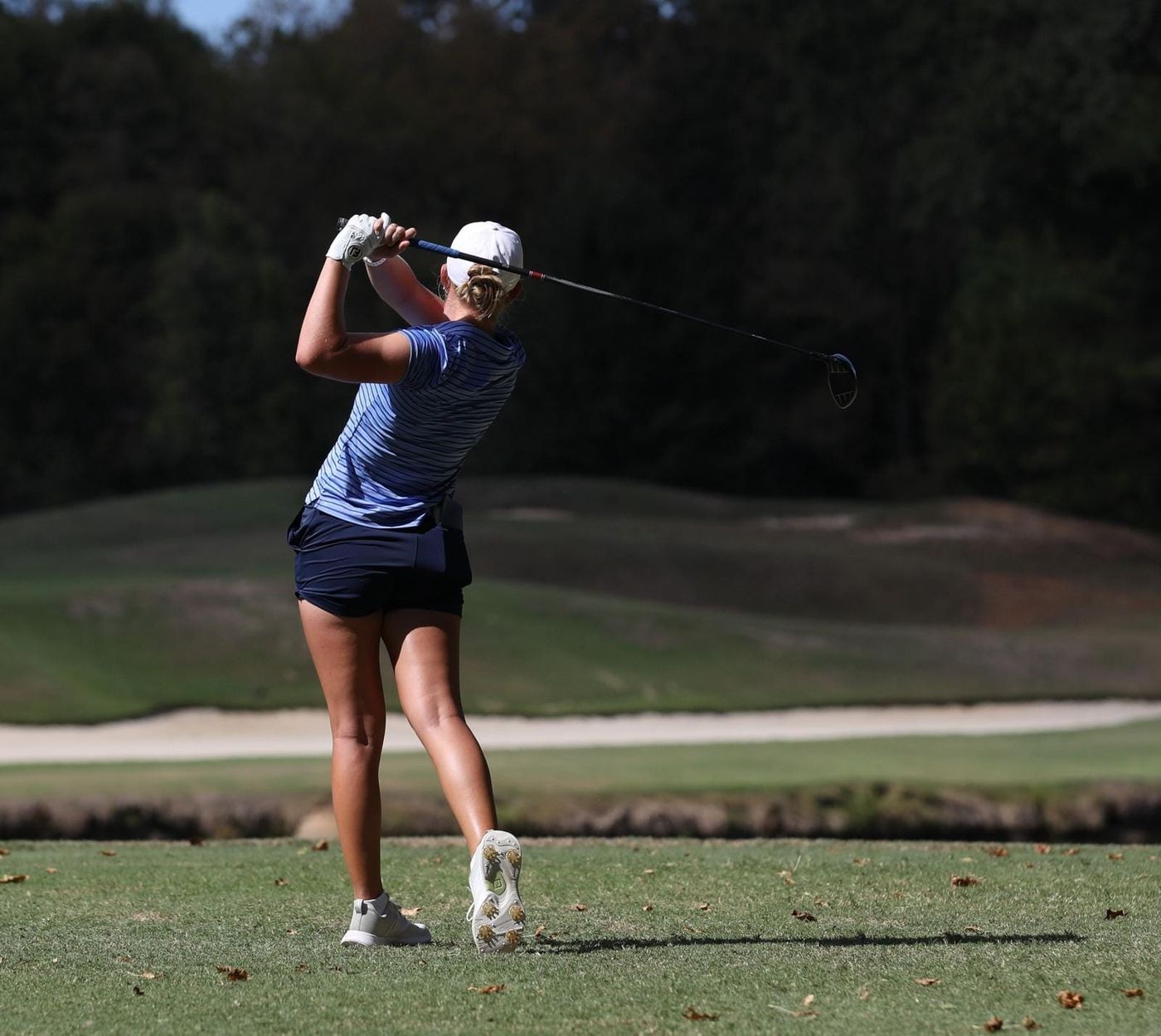 Florida women's golfer Sophia Dyer follows through on a tee shot