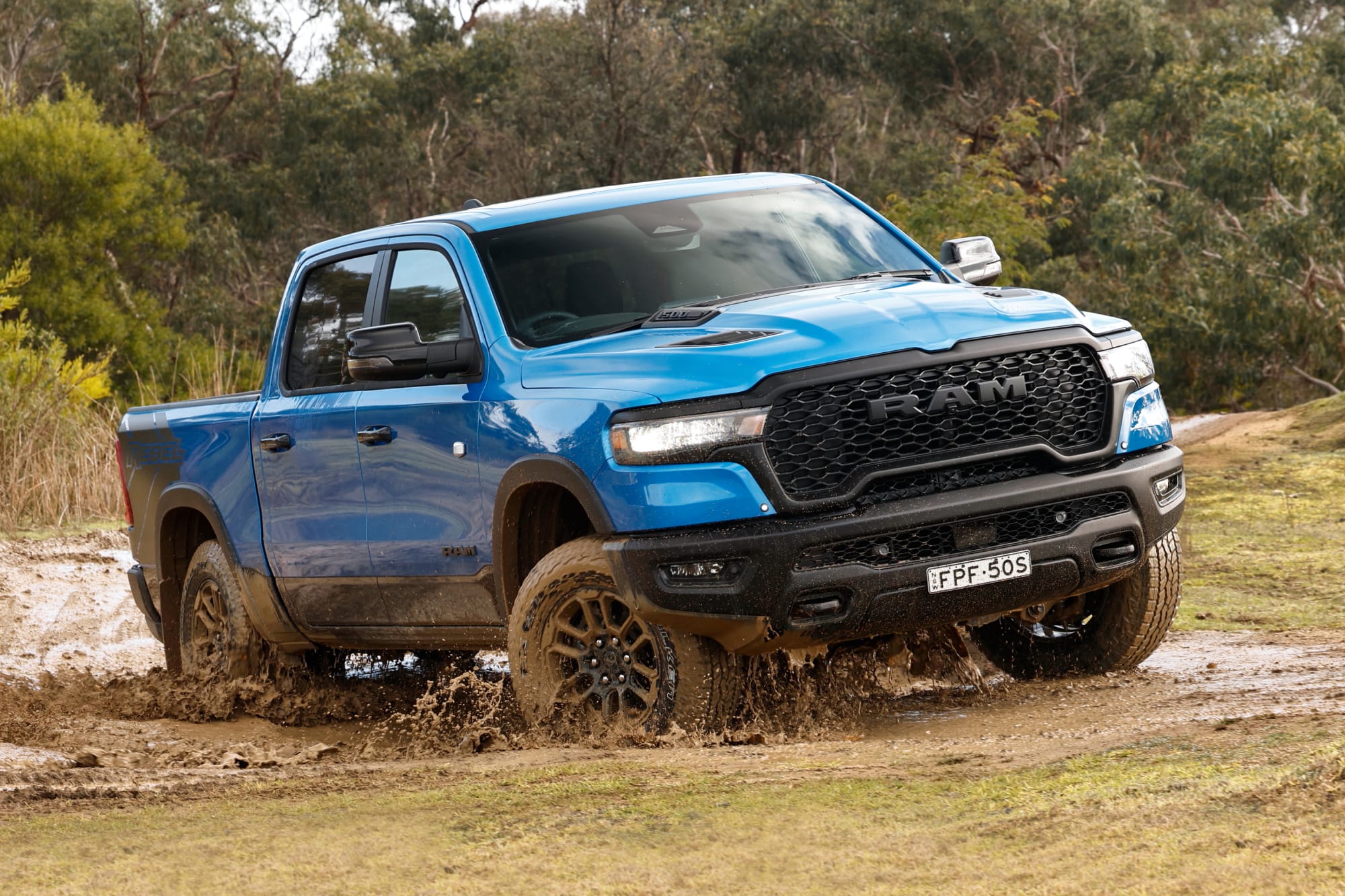 Ram 1500 Rebel driving through mud