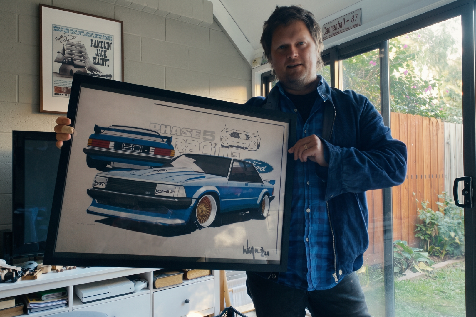 Rob Draper holding a Phase 5 design sketch by father Wayne