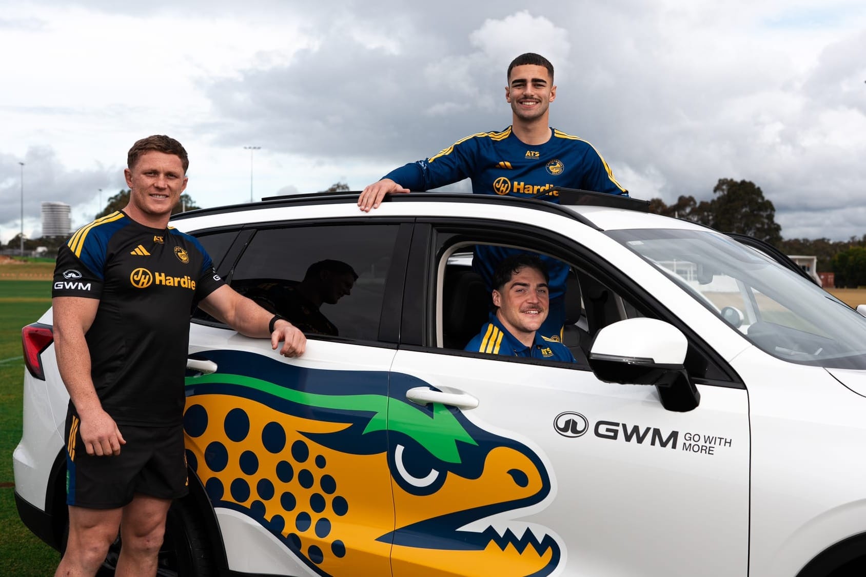 Parramatta Eels players with a GWM car