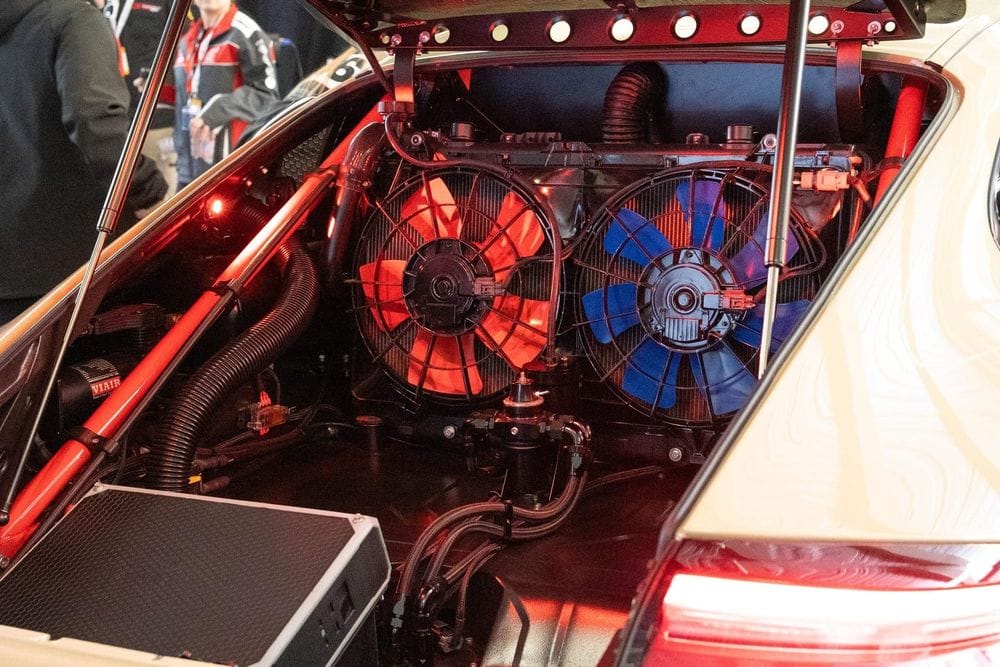 Two radiators with orange and blue thermo fans mounted in the rear of a modified Porsche 911