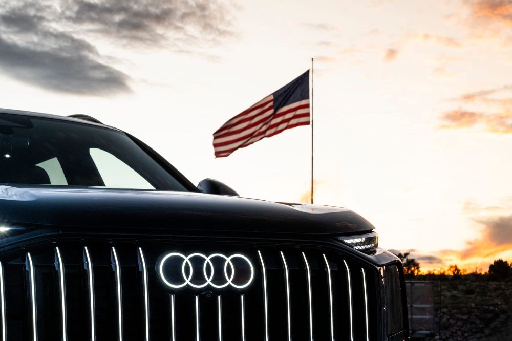 An Audi Q9 in front of the American flag