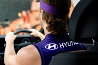 A man wearing a Fremantle Dockers guernsey in a Hyundai