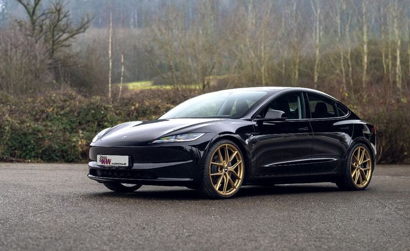 Black Tesla Model 3 Performance fitted with KW DDC coilover suspension and gold aftermarket wheels.
