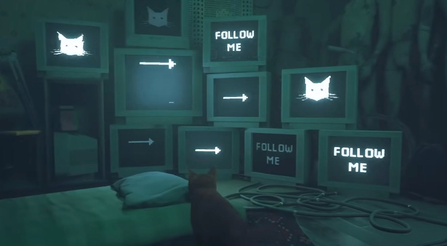 A screen capture from STRAY: the little orange tabby faces many computer screens reading "Follow me" with a cat symbol and pointing arrows to guide you.