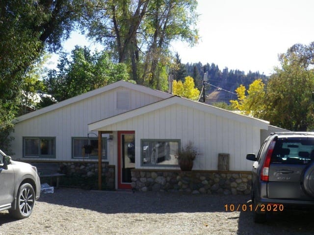 The house at 929 Pine St. on Oct. 1, 2020, about a year before the city permitted the garage and apartment behind it. Its vertical wood siding and cultured river-stone wainscot are the kind of changes a 2003 city survey said ruled it out for historic listing. (Routt County Assessor’s Office; license plate blurred by the Independent.)