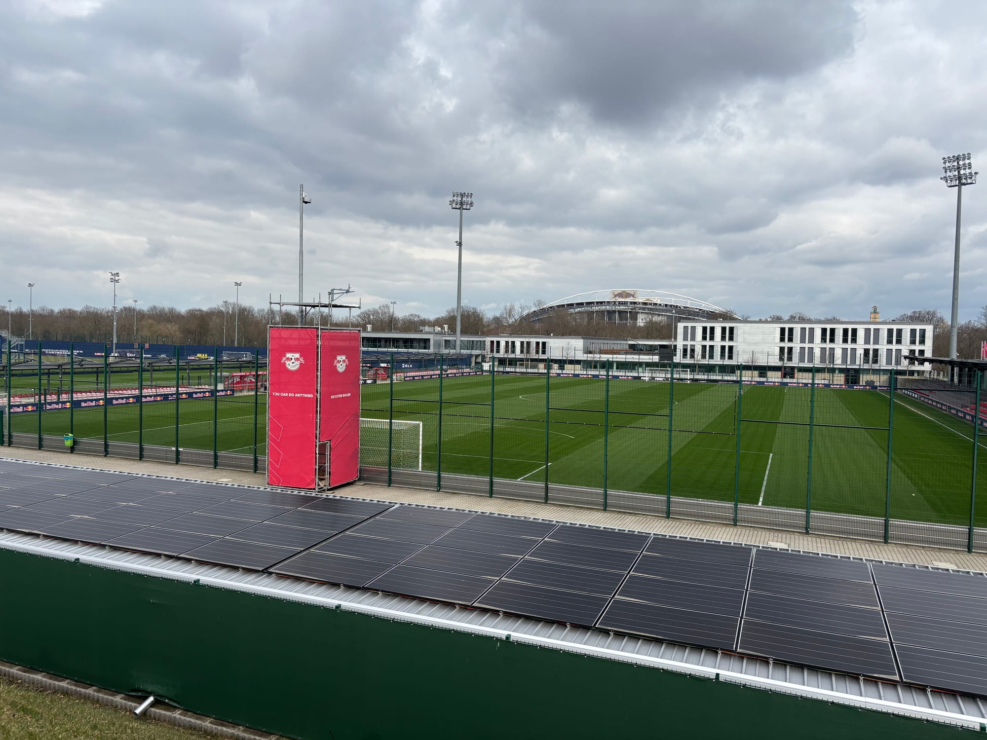 Red Bull's training complex spread out below, with RB Arena looming out of the grey clouds above it