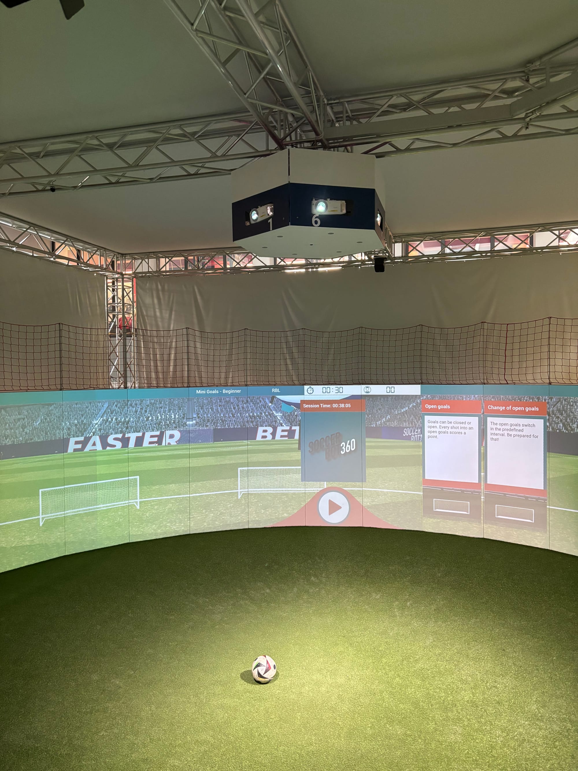 A 360-degree wall of interactable touchscreens surround an area to play football