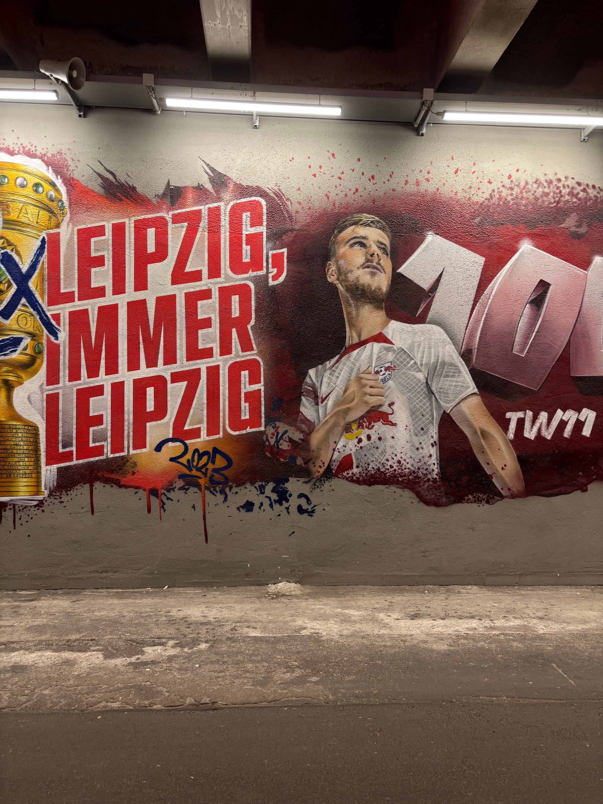 A mural inside RB Arena depicts Timo Werner and reads 'Leipzig, immer Leipzig' (Leipzig, always Leipzig)