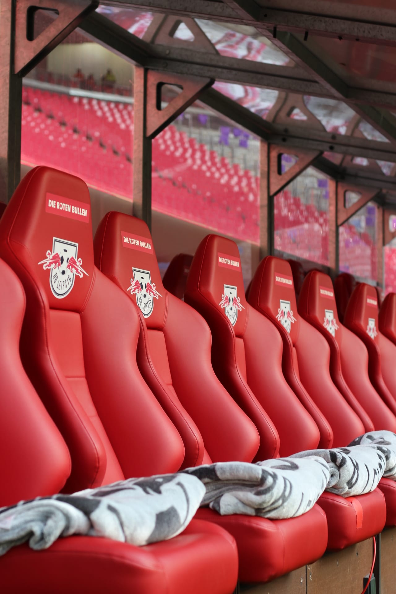RB Leipzig's bright-red home bench, RB Arena, with towels already in place for the players