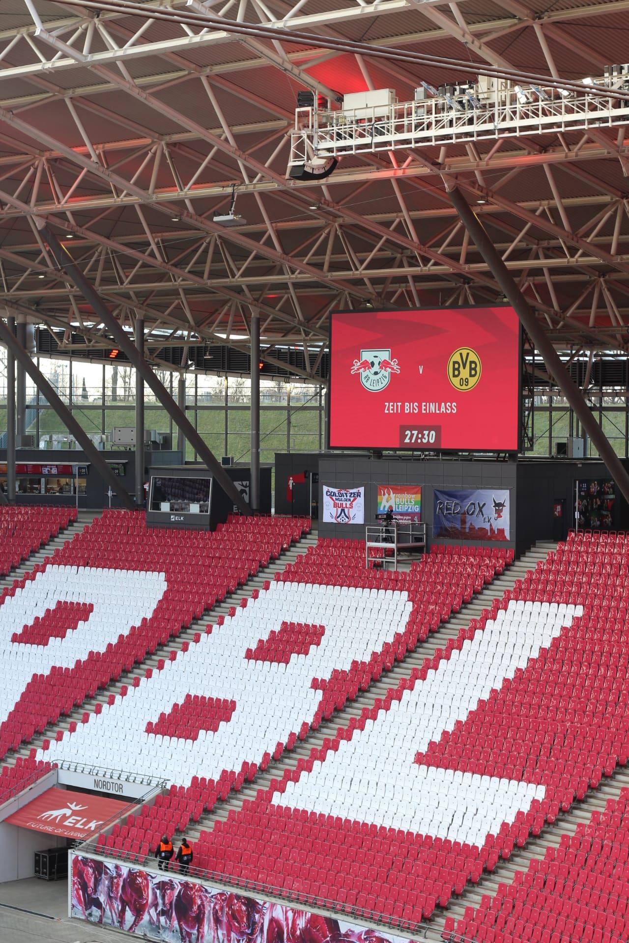 The stands in RB Arena. A screen displays a preview for the upcoming game with Borussia Dortmund.