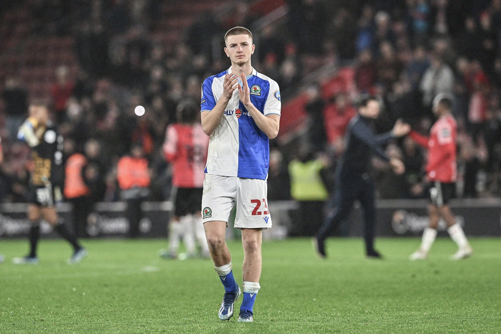 A photo of Adam Wharton clapping the fans in a Blackburn Rovers shirt