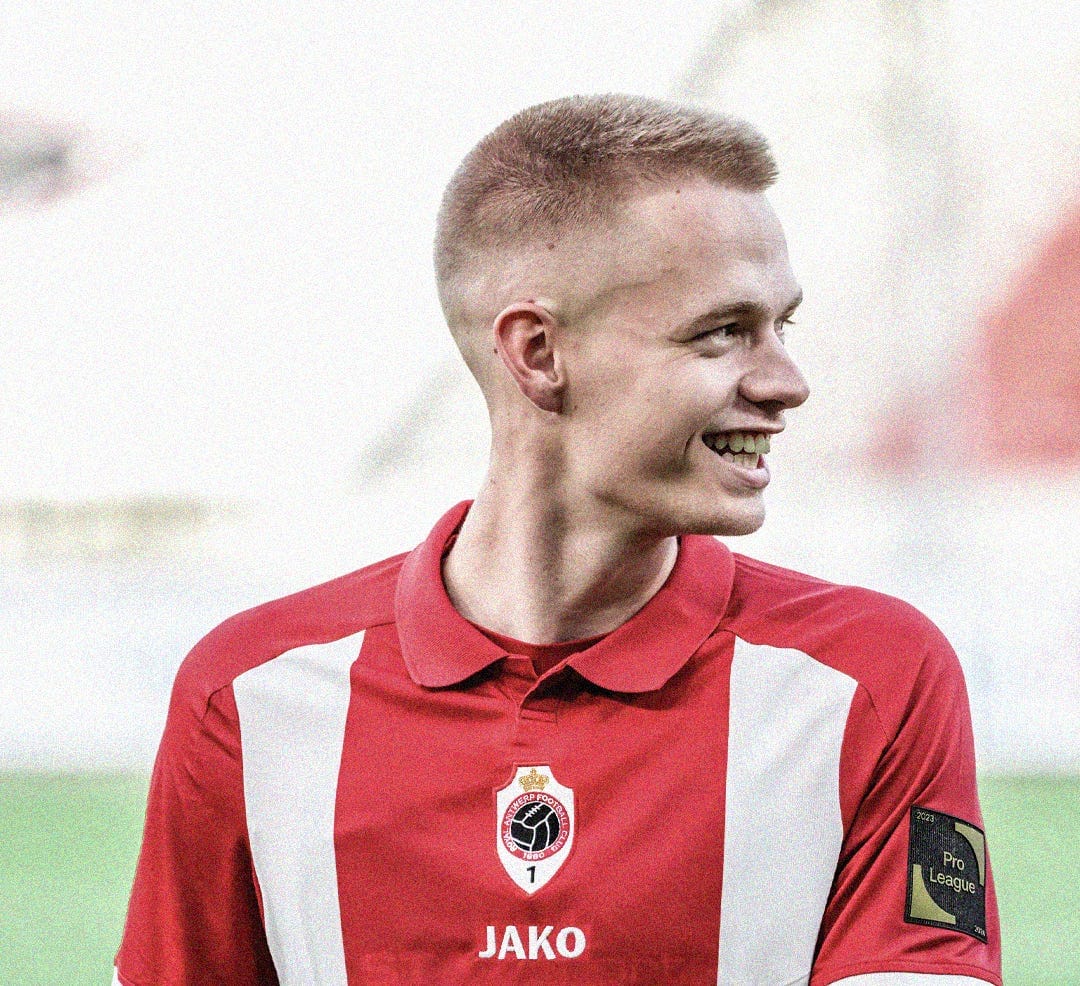 A close-up photo of Arthur Vermeeren wearing a red-and-white Royal Antwerp kit