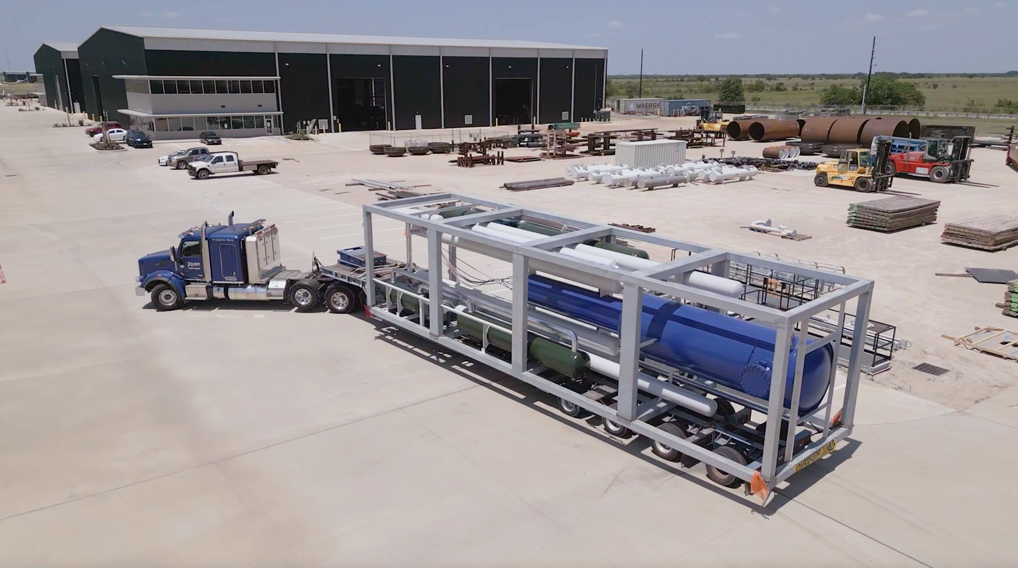 A semitruck tows an SMR made by Last Energy to a new location.