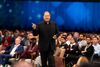 Salesforce CEO Marc Benioff speaks at Dreamforce 2025 in front of an audience wearing a black suit