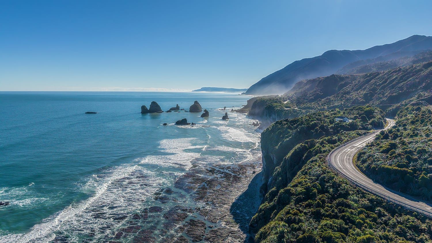 Coast Road, West Coast New Zealand, winds around the mountains on the edge of the Tasman