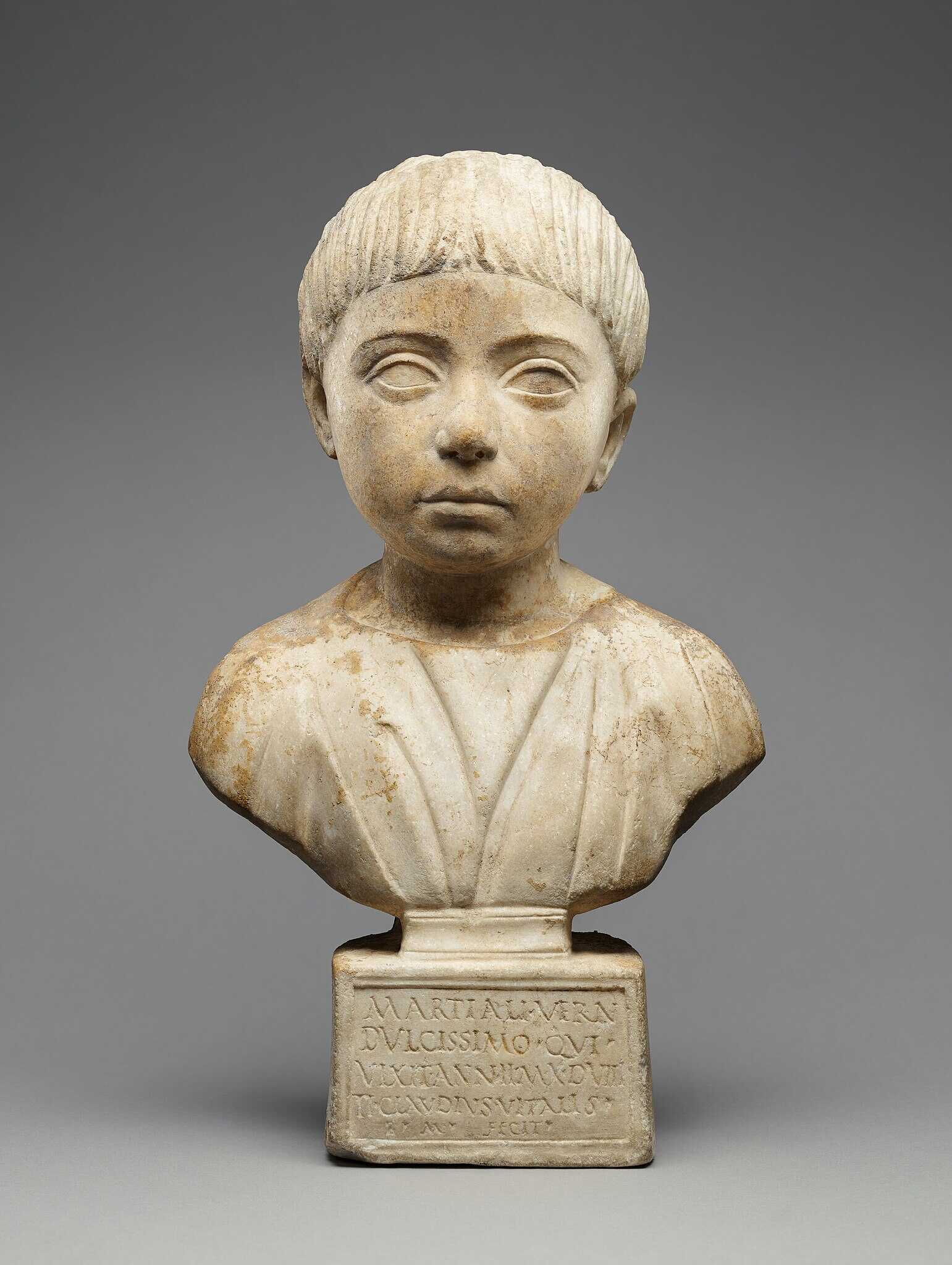 An Ancient Roman portrait bust of a house-born slave child, named  Martial, who lived two years, ten months, and eight days, and was probably the child of the house owner and an enslaved mother