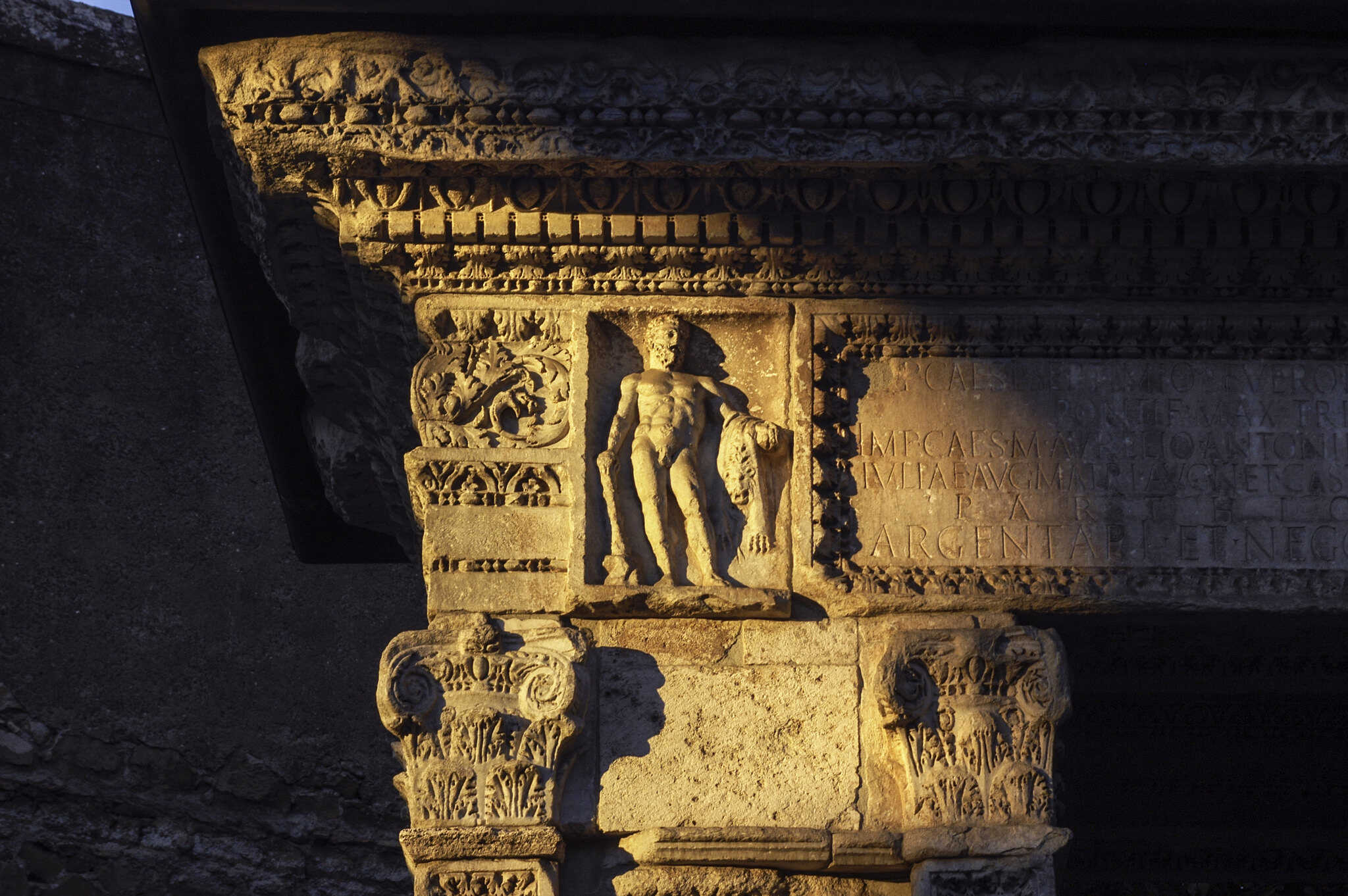 The Arch of the Argentarii (Arch of the Money-changers, is today partly incorporated into the church of San Giorgio Al Velabro) at sunset, Hercules in the detail
