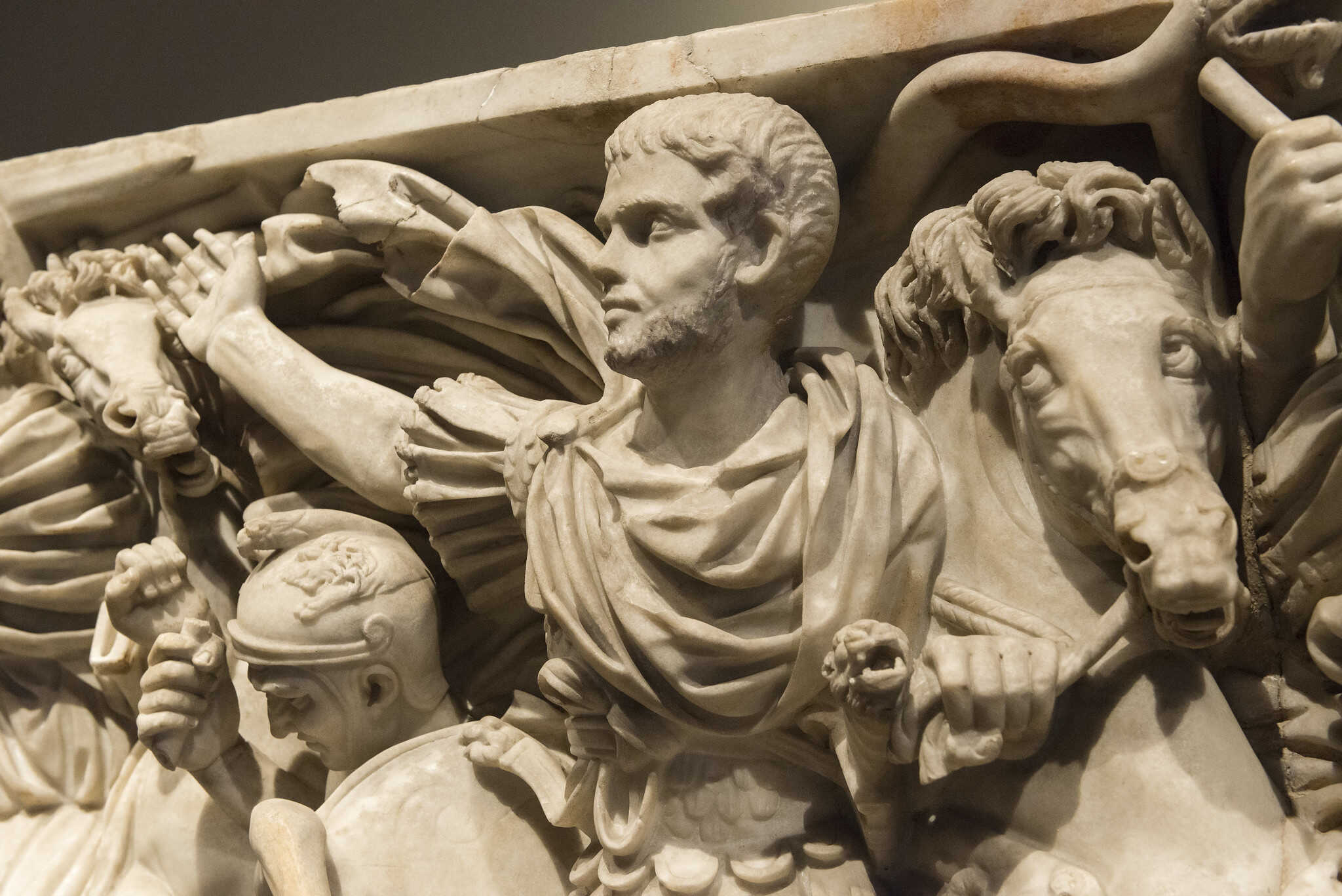 The Ludovisi Sarcophagus possibly depicts Hostilian, son of Emperor Decius, in battle against the Goths, as a Roman general, a Mithraic cross on his forehead links him to the Persian god of light