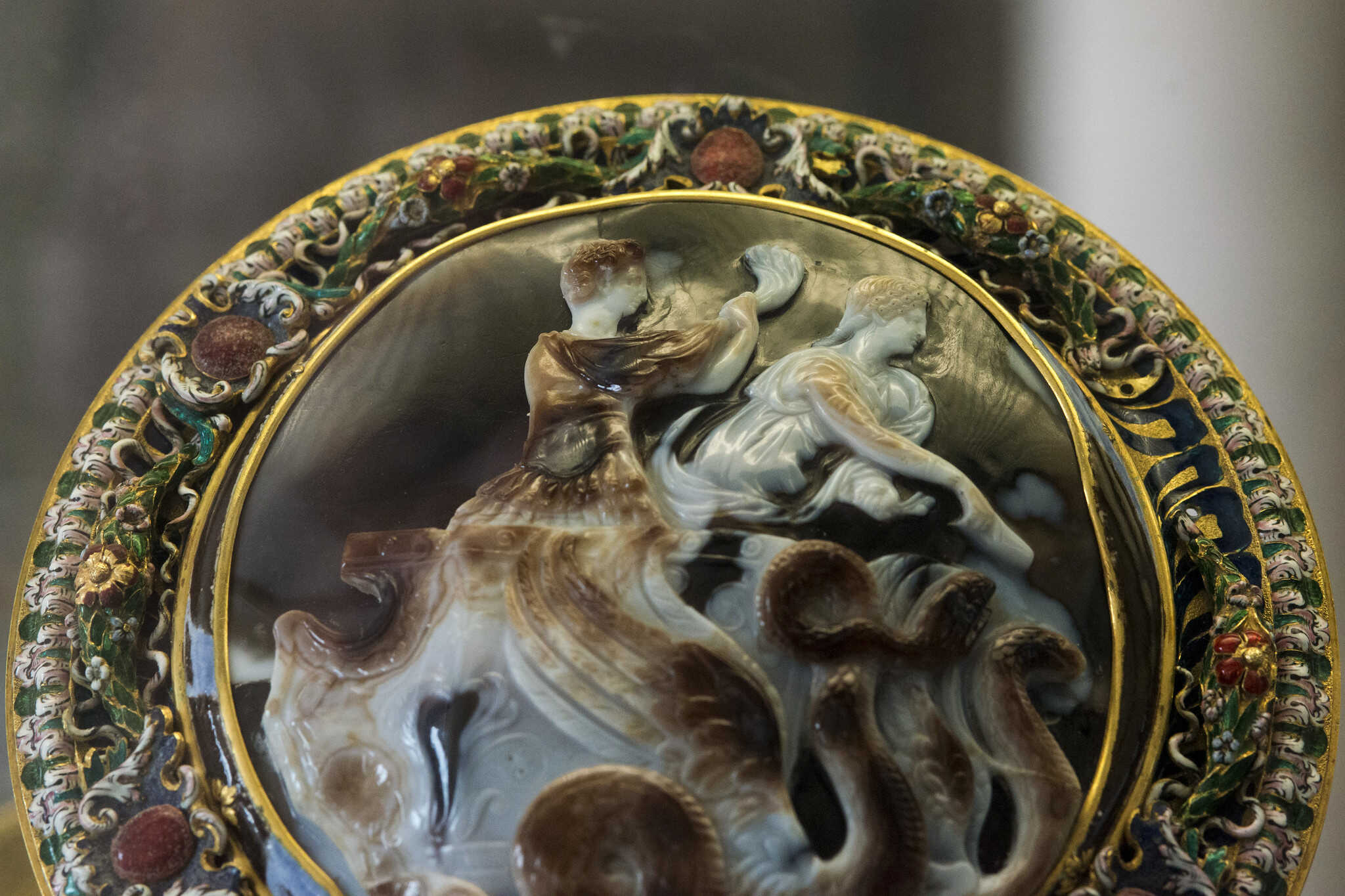 A Sardonyx cameo in three layers with enameled gold, depicting Emperor Claudius and his wife Messalina on a chariot drawn by winged snakes