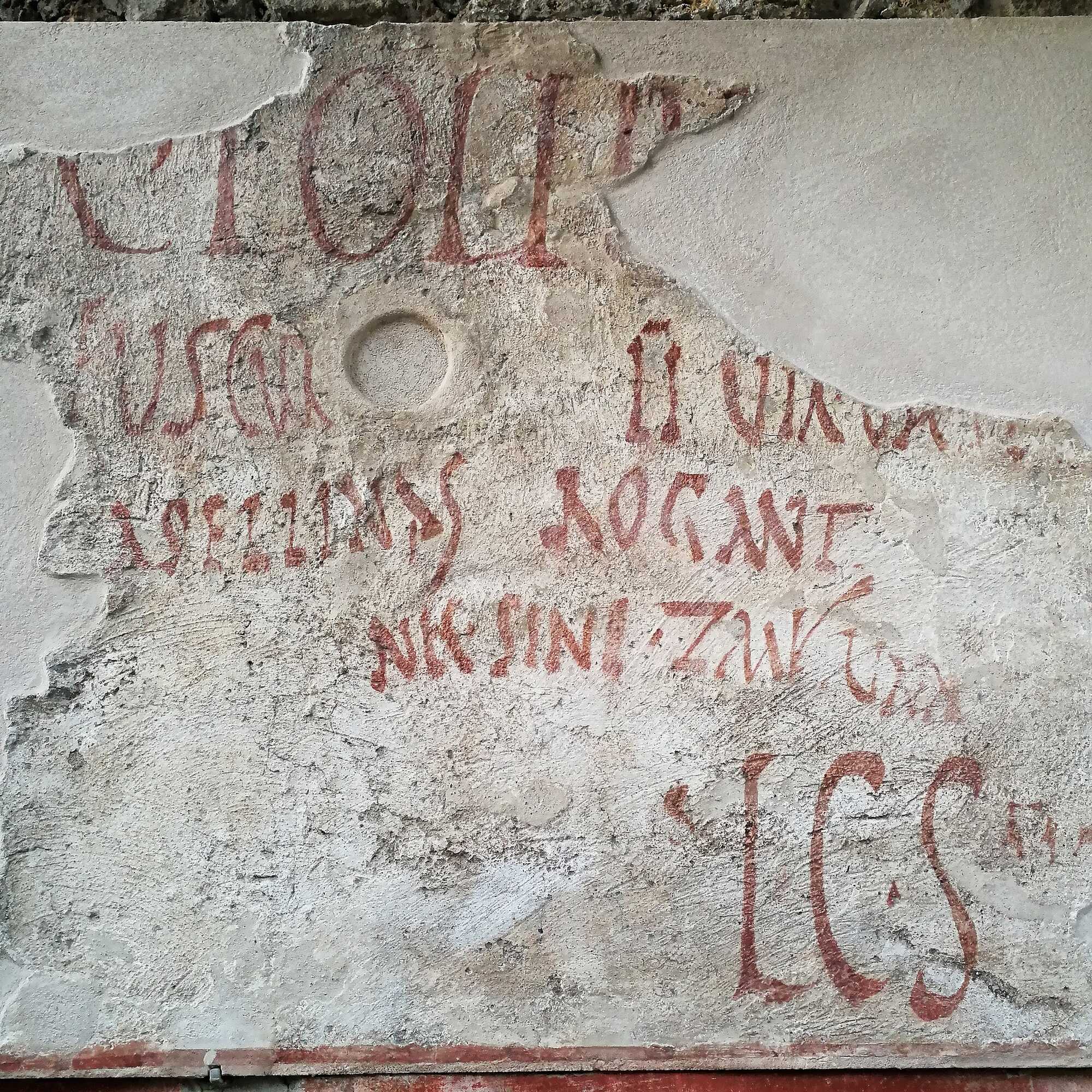 An election poster found in Asellina's Tavern in Pompeii, saying "Asellina's girls, including Zmyrina, ask for the election of Caio Lollius Fuscus as duumvir"